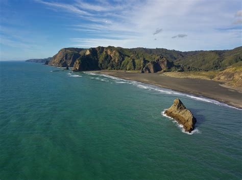 A drone's-eye view of Karekare Beach, Saturday evening : r/auckland