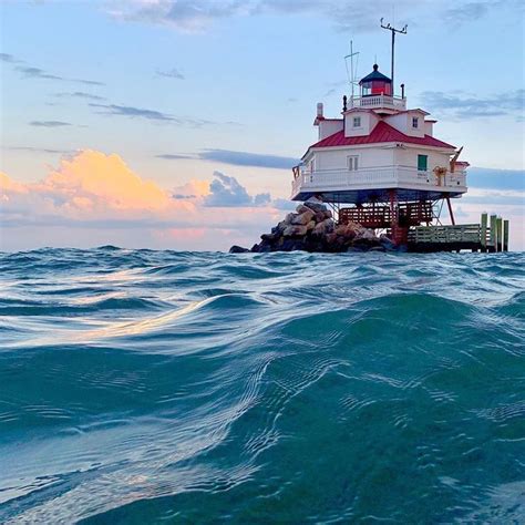 a light house sitting on top of a rock in the ocean