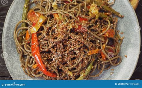 Soba with Vegetables in Soy Sauce in a Plate Sprinkled with Flax Seeds ...