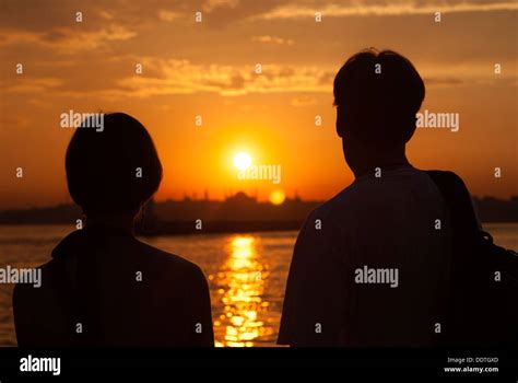 Two people at sunset Stock Photo - Alamy