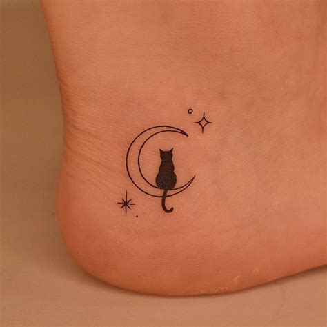 Crescent moon and black cat tattoo done on the ankle,