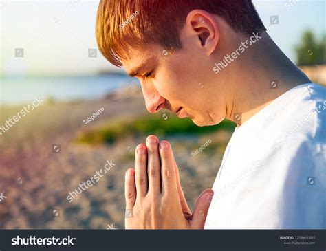 Young Man Praying On Nature Background Stock Photo 1259411089 ...