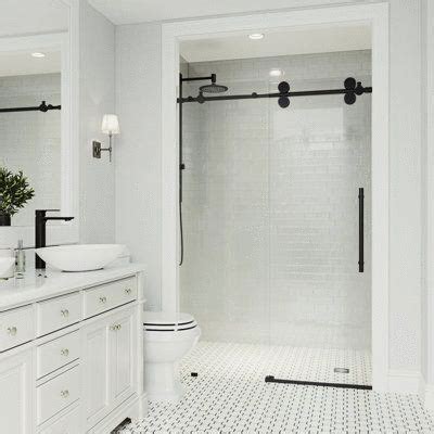 a white bathroom with two sinks and a walk in shower