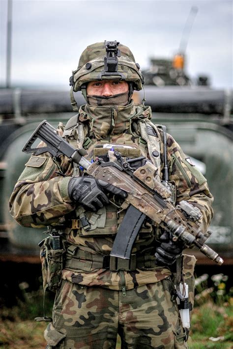 A Polish soldier monitors a critical intersection while conducting security operations during ...