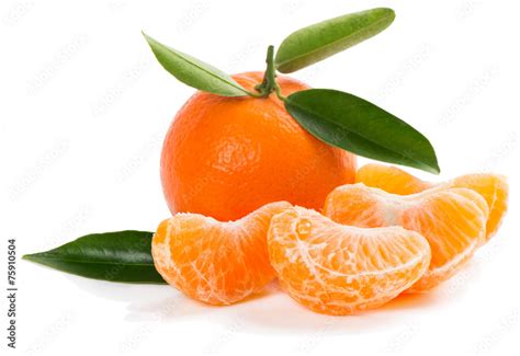 unpeeled tangerine with green leaves and slices Stock Photo | Adobe Stock