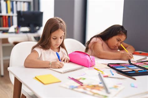 Two Kids Preschool Students Sitting on Table Drawing on Paper at Classroom Stock Photo - Image ...