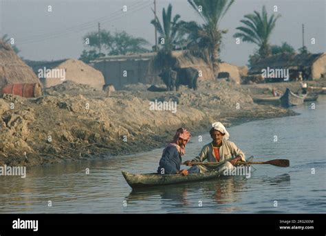 Marsh Arabs Iraq. Marsh Arab men in boat, adobe homes, houses and ...