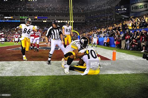 Pittsburgh Steelers Santonio Holmes victorious, sitting out of bounds ...