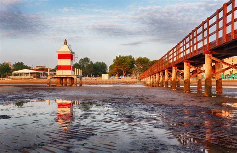 Italy Beach - Lignano Sabbiadoro Lighthouse with Beach at Sunrise Stock ...