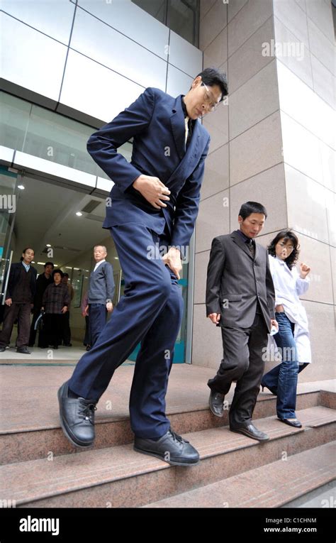 The world's tallest person, Zhang Juncai, (who stands at 7ft 9ins tall ...