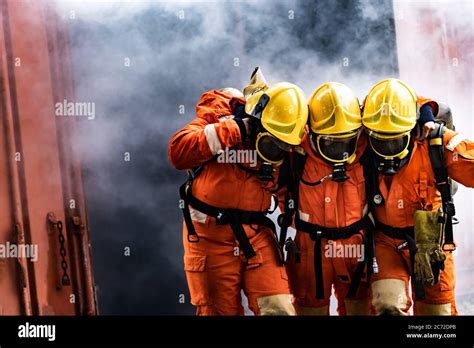 Asian firefighters rescue their team colleague from from burning ...