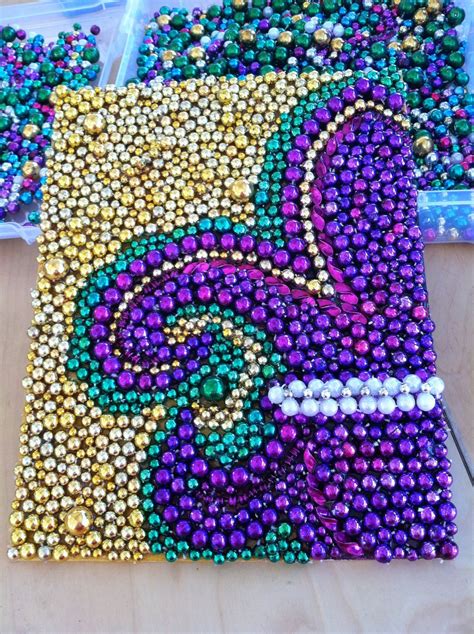 by Amy Lauzon. Mardi Gras bead Fleur de Lis glued on canvas board ...