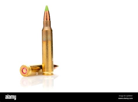 A pair of 5.56 calibar, green tip bullets ordered into the line on white background Stock Photo ...