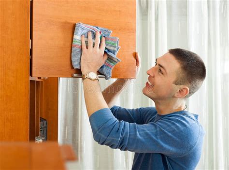 Happy Man Dusting Furniture At His Living Room Stock Photo - Image ...