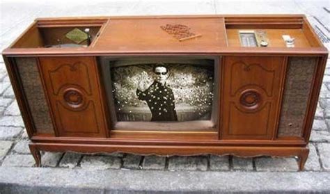 Old tv console with sliding doors on top. One side a radio, the other a record player. My ...