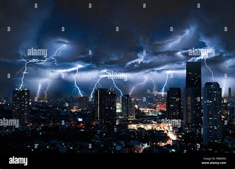 Lightning storm over city in blue light Stock Photo - Alamy