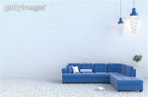 White living room decor with blue sofa, white wood wall, pillow, bedside table, grey white ...