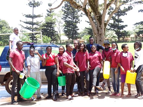 UCU students wash cars to raise money for sanitary pads - Uganda Christian University Partners