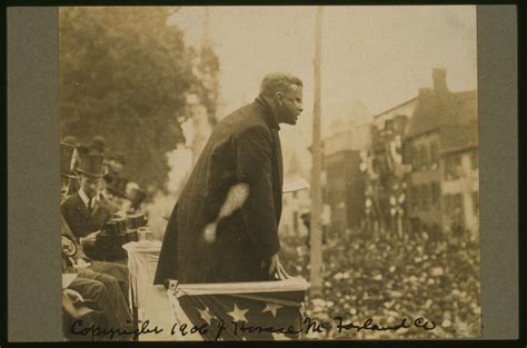 [President Theodore Roosevelt addressing a crowd from a flag-draped ...