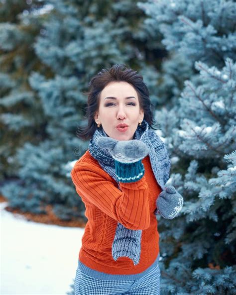 Woman is Posing in Winter Forest, Beautiful Landscape with Snowy Fir Trees. Dressed in Red ...