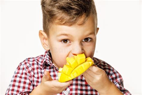 Handsome Boy in a Red Shirt is Eating a Mango Stock Photo - Image of ...