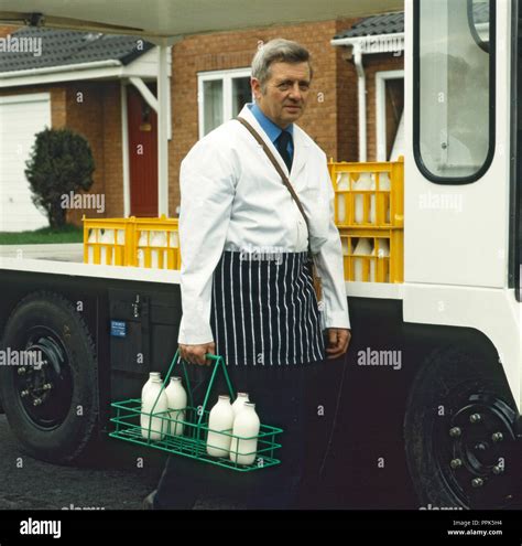 Doorstep milk delivery with milkman and milk float Stock Photo - Alamy