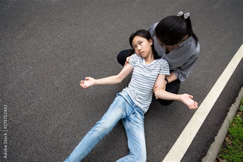 Sick child girl with epileptic seizures on street,daughter suffering from seizures,illness with ...