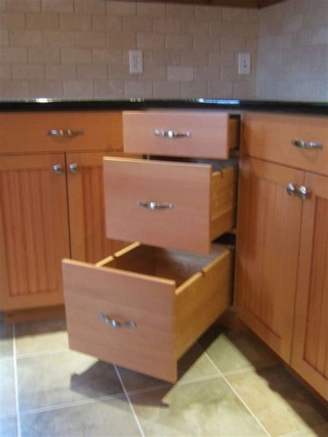 Instead of a lazy susan or blind pullout, how about these angle drawers ...