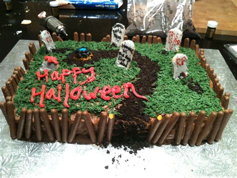 Halloween graveyard cake I made for a party. The dirt is oreos, with a chocolate finger fenc ...