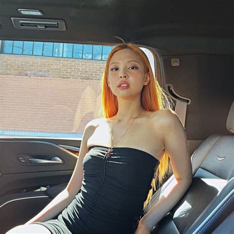 a woman sitting in the back seat of a car wearing a strapless black dress