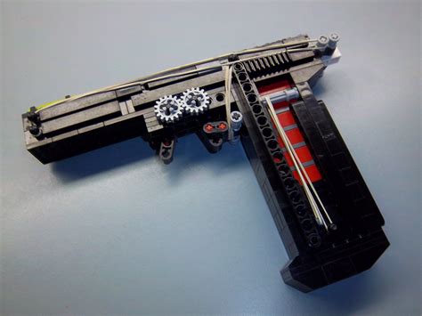 A working LEGO pistol. Lego Diy, Lego Craft, Technique Lego, Modele Lego, Lego Guns, Lego Boxes ...