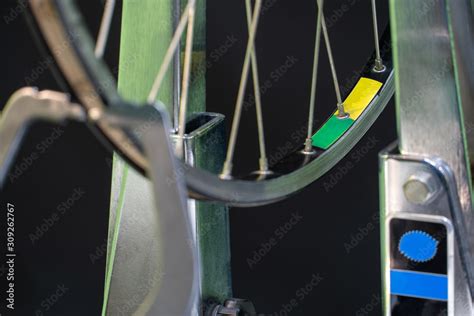 Bicycle repair. The front wheel is on a stand on a black background ...