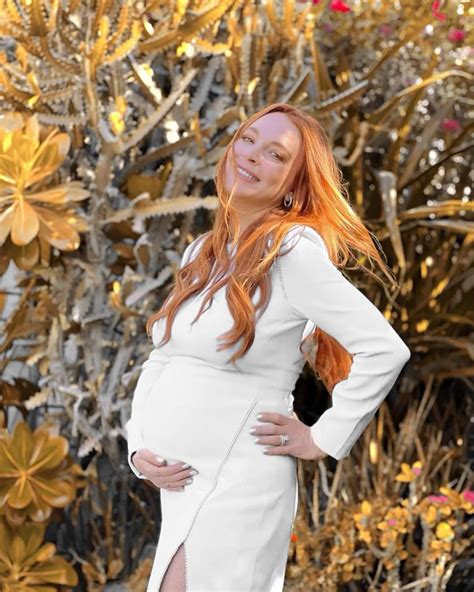 Pregnant Lindsay Lohan cradles bump in glowing baby shower pics