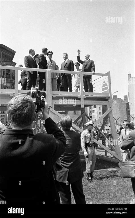 US president John F. Kennedy (l) at a view point at the Berlin wall on 26 June 1963. At right ...