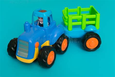 Toy Blue Tractor with a Trailer on a Blue Background.Close-up. Stock ...