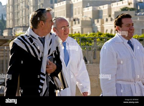 Jewish men dressed in traditional religious clothes go to the Wailing Wall at Yom Kippur in the ...