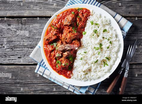 close-up of Beef Stew in tomato sauce with spices and herbs served on a ...