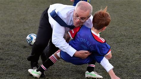 Australian PM Scott Morrison accidentally rugby tackles boy during football match at election ...