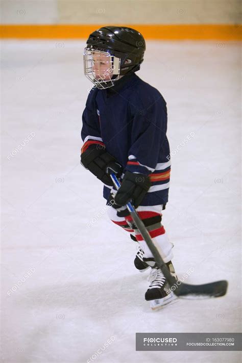 Child Playing Hockey on ice indoors — winter, ice skating - Stock Photo ...