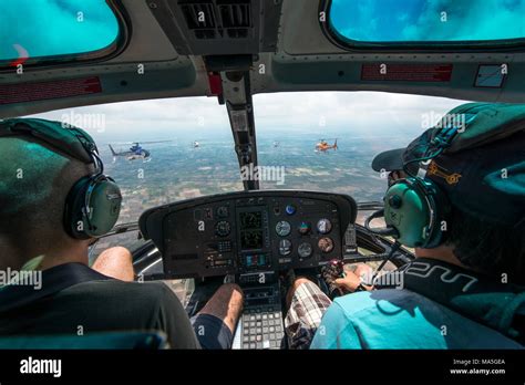 Interior shot in flying Airbus Eurocopter helicopter AS350, showing cockpit with pilot and ...