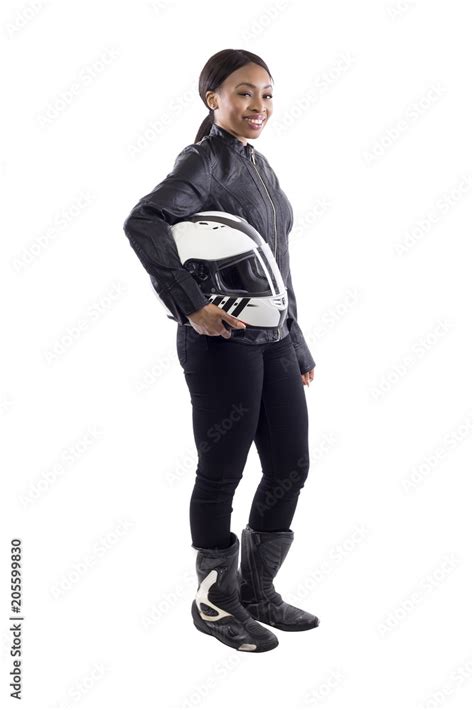 Confident strong black female holding a helmet as a race car driver, motorcycle biker or a ...