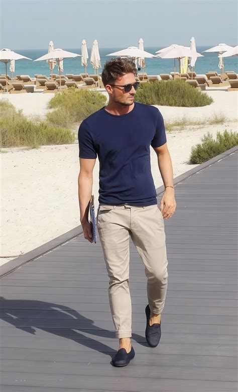 Picture Of a simple summer outfit with a navy tee, tan pants and black loafers