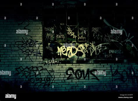 Dark Grungy alleyway with graffiti covered wall texture Stock Photo - Alamy