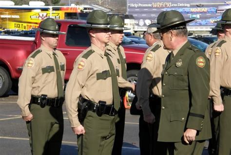 several police officers are standing in a parking lot