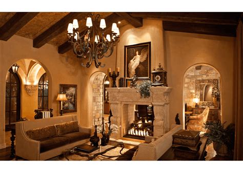 Spanish Villa with an elegant fireplace and chandelier above traditional home decor. | Living ...