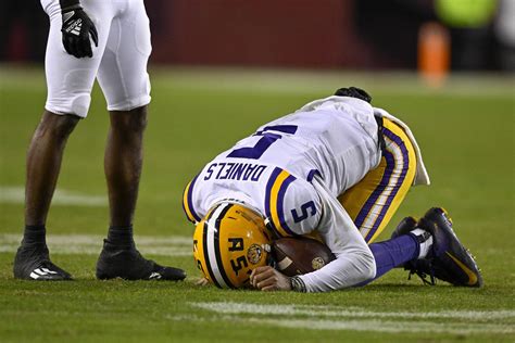 LSU's Jayden Daniels in boot after ankle injury