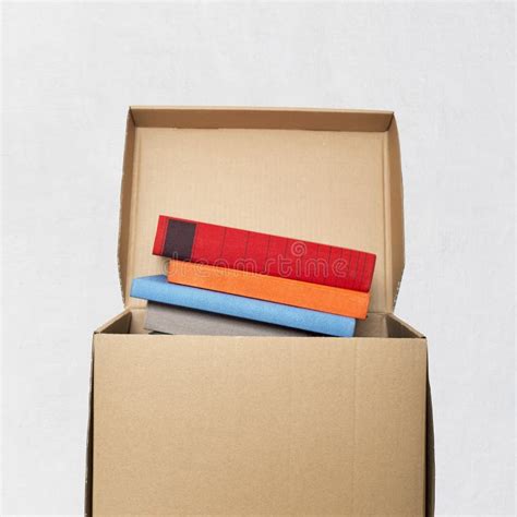 Packing Books In A Cardboard Box Stock Photo - Image of package ...