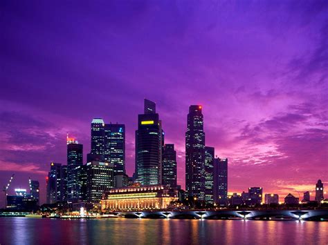 Download City Background Singapore Skyline Under Night Sky Wallpaper | Wallpapers.com