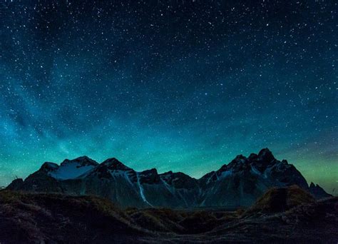 A beautiful green colour appearing in the night sky behind the mountains of Vestrahorn, Iceland ...