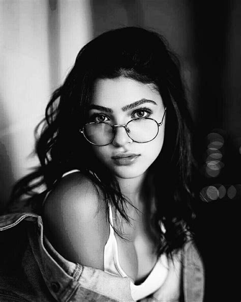 black and white photo of a woman wearing glasses